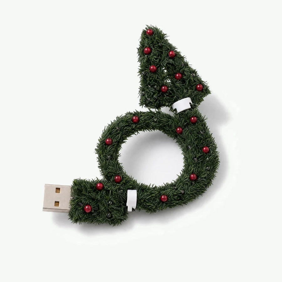 The little tree plugged into a USB charger at the outlet, glowing