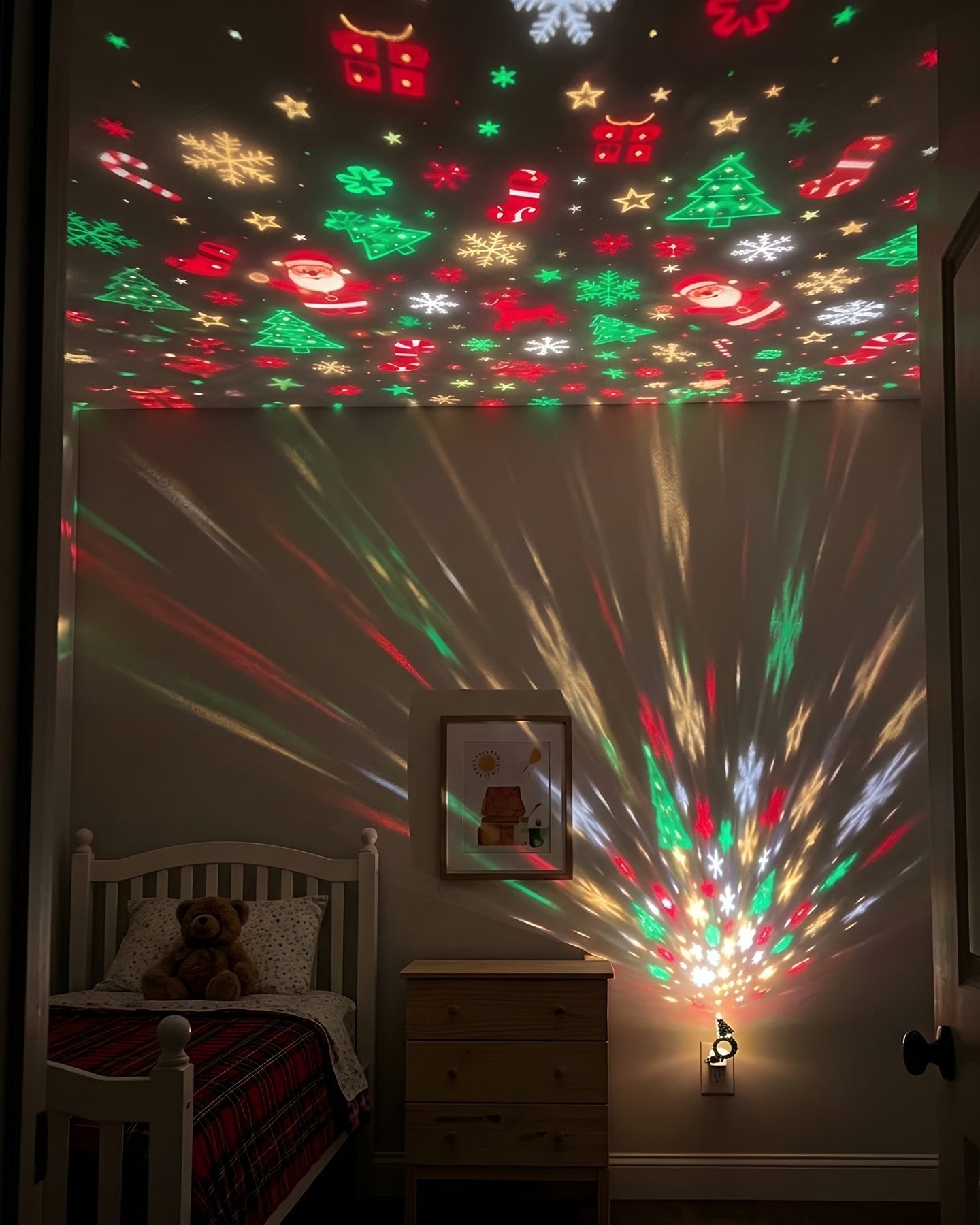 The same bedroom with the Tiny Tree Light plugged in, Christmas shapes covering the walls and ceiling