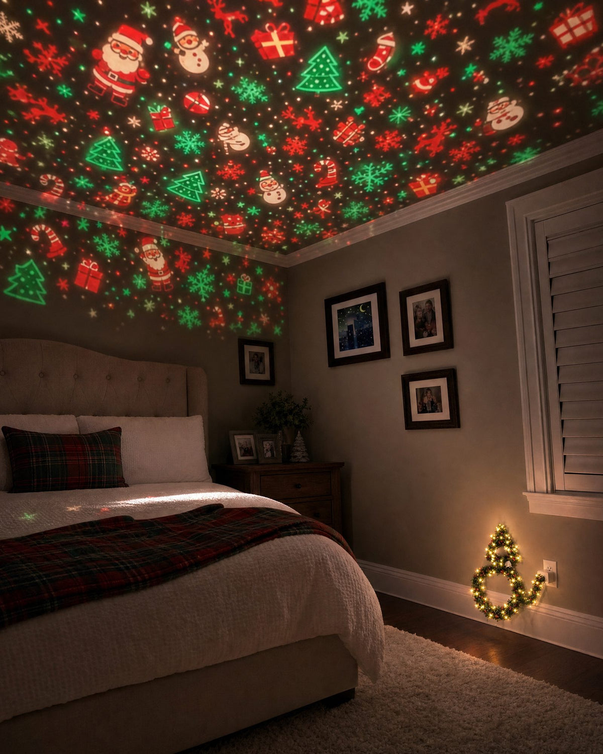 A dark bedroom with the ceiling covered in Santas, trees and snowflakes, the little light glowing at the outlet